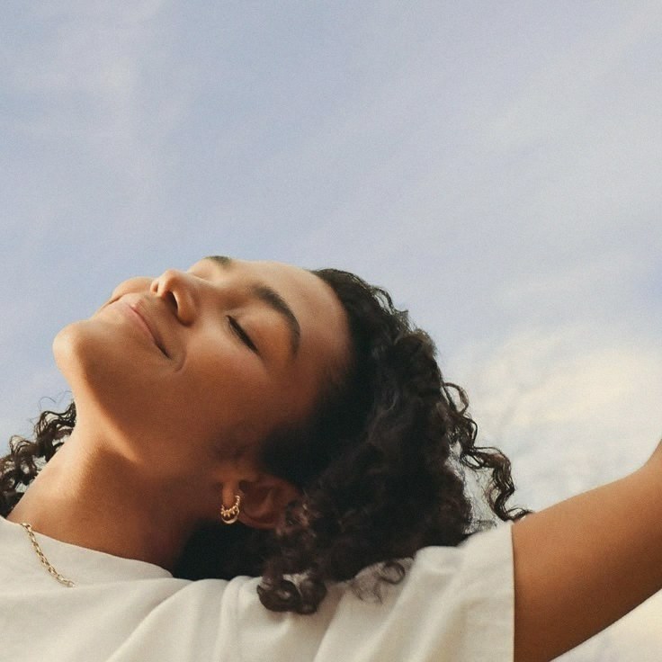 A woman with her face turned up to the sky
